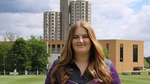 Student stood in front of towers accomodation